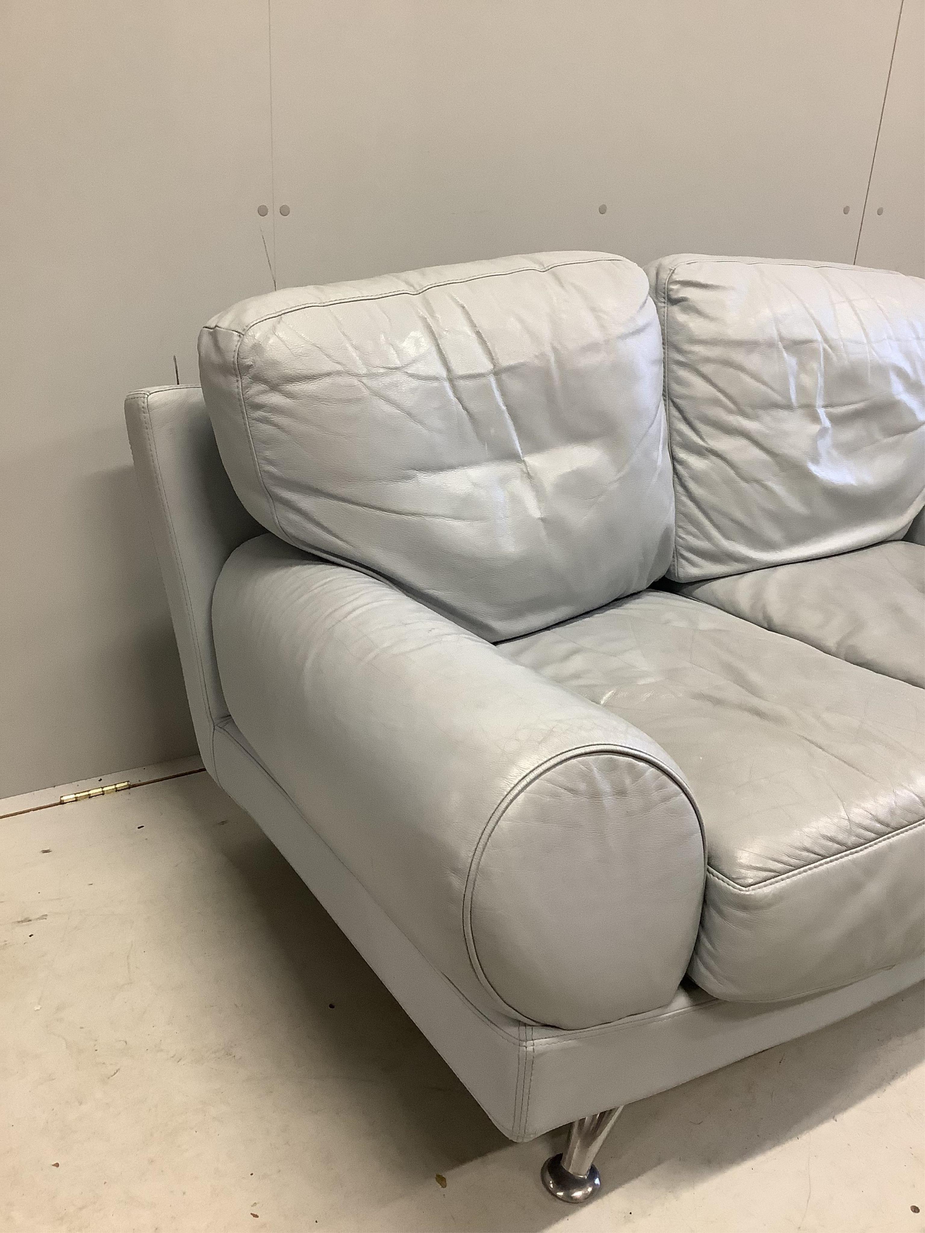 A pair of Contemporary Italian style pale blue leather sofas, width 160cm, depth 84cm, height 80cm. Condition - poor to fair